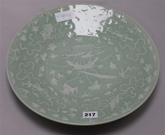 A Chinese white slip decorated celadon dish 35cm.